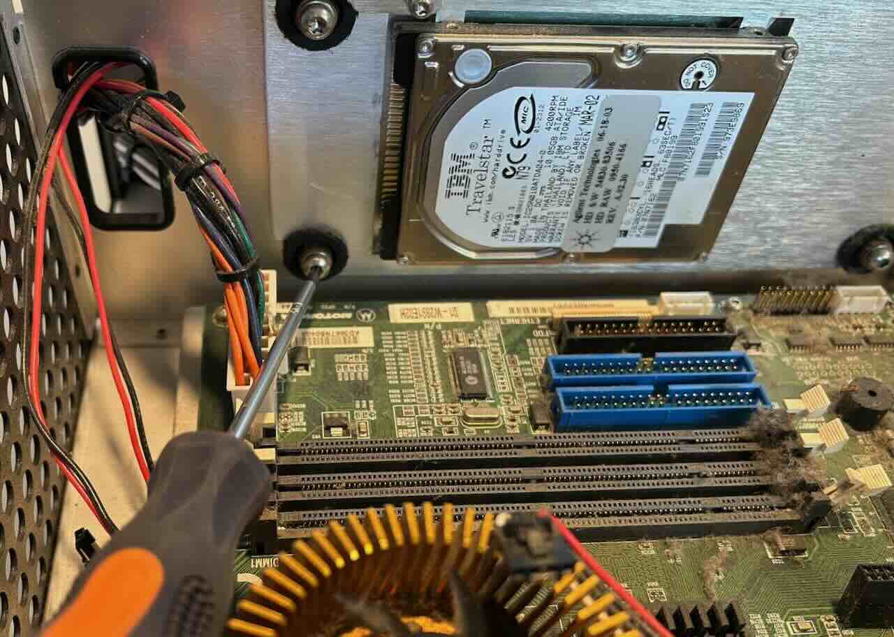 Screwdriver in bottom left hard drive platform screw