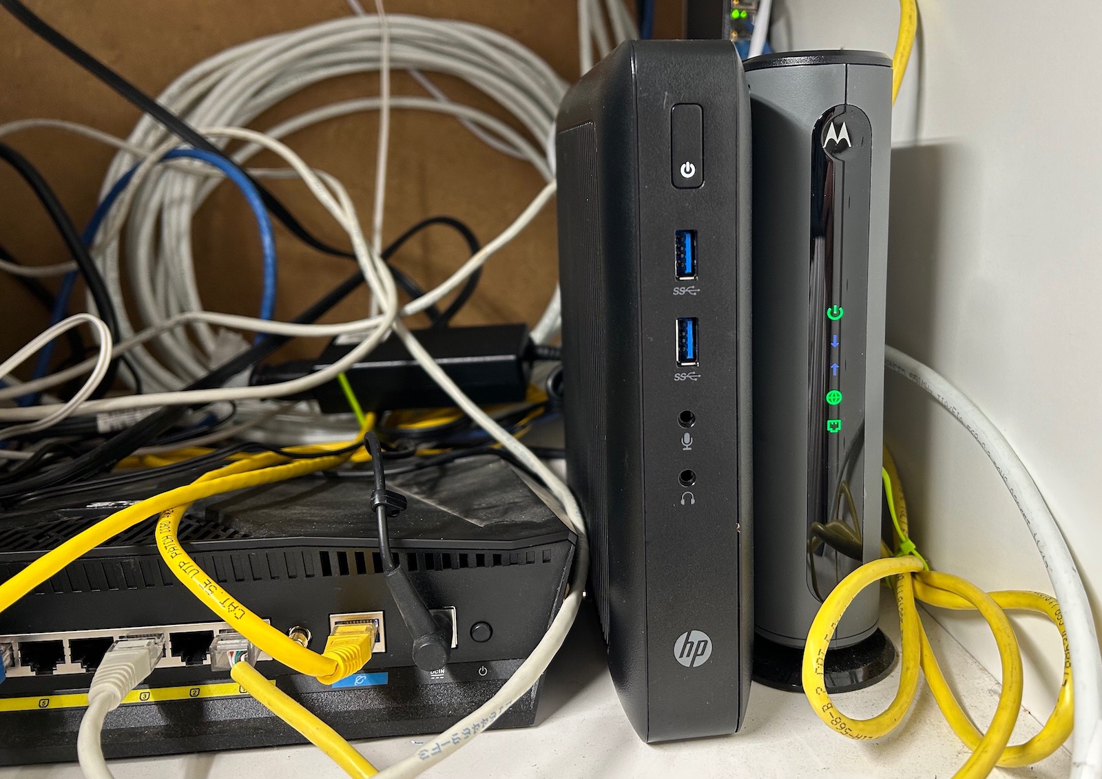 HP t520 next to cable modem in a closet